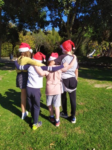 cousins together at christmas wearing christmas hats