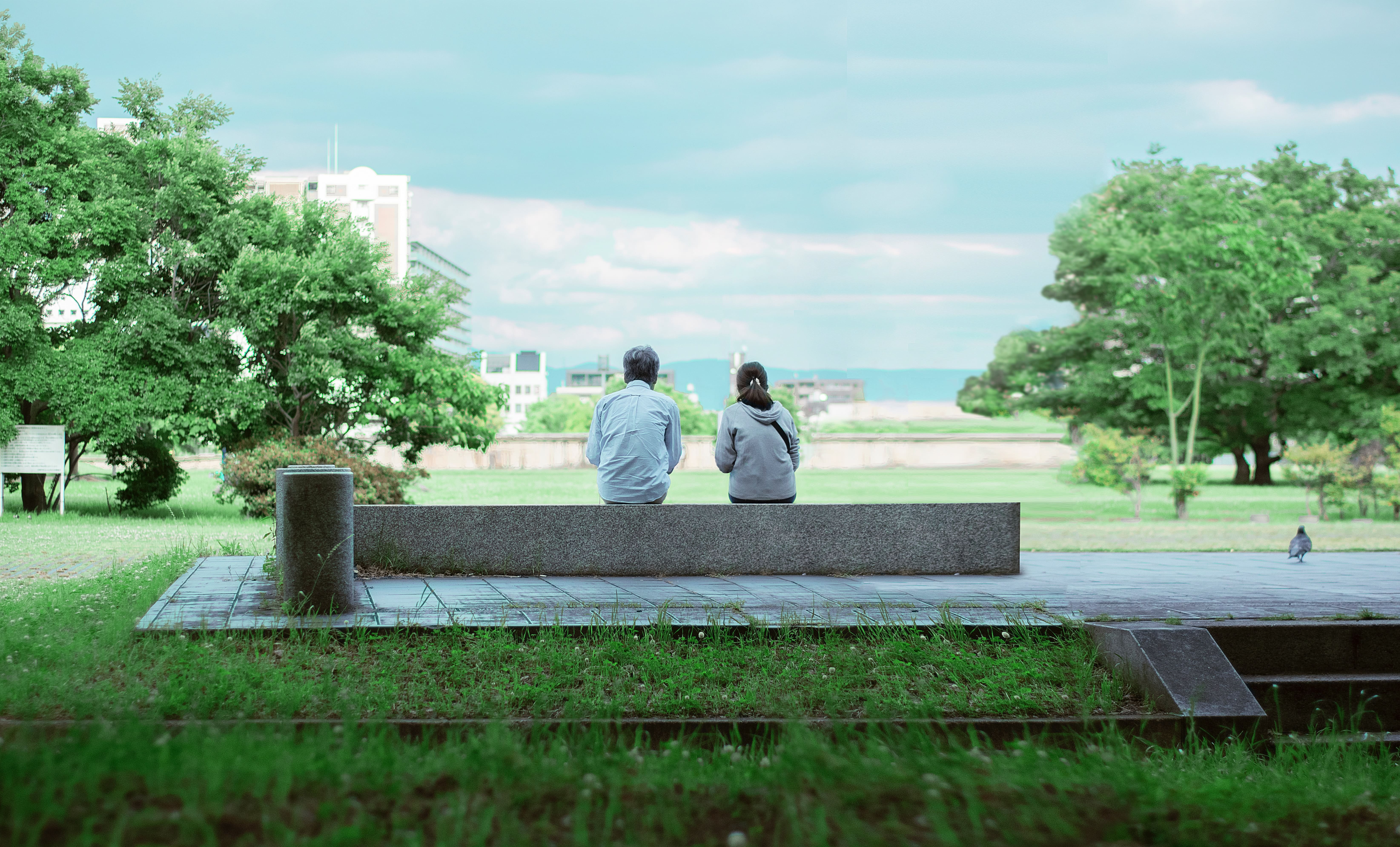 Couple outside in a park on a bench