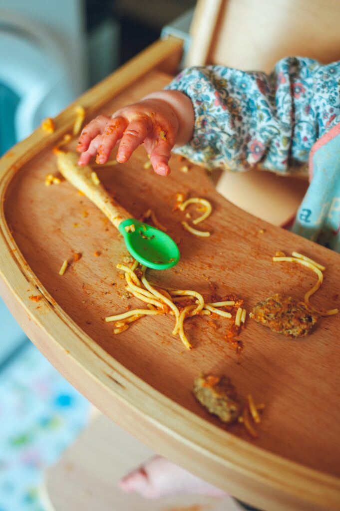 toddler intuitively eating spaghetti messily