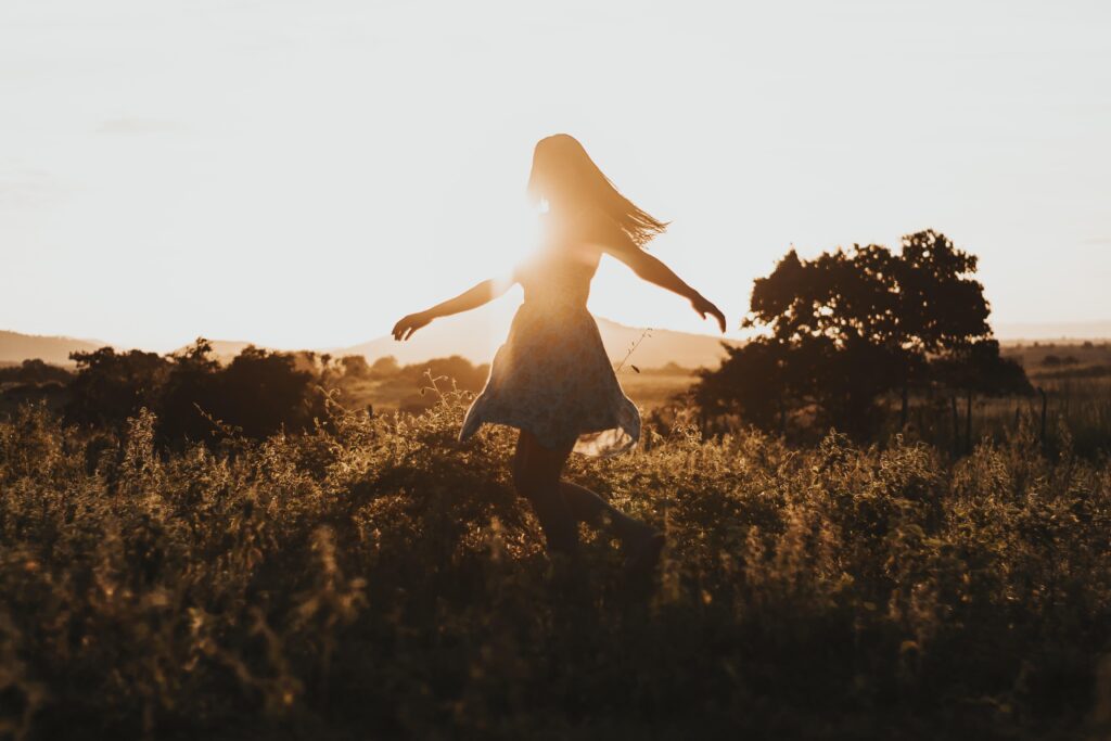 girl freedom in field sunshine