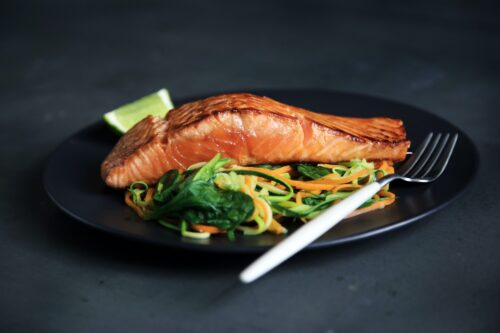 salmon cooked on plate with salad delicious