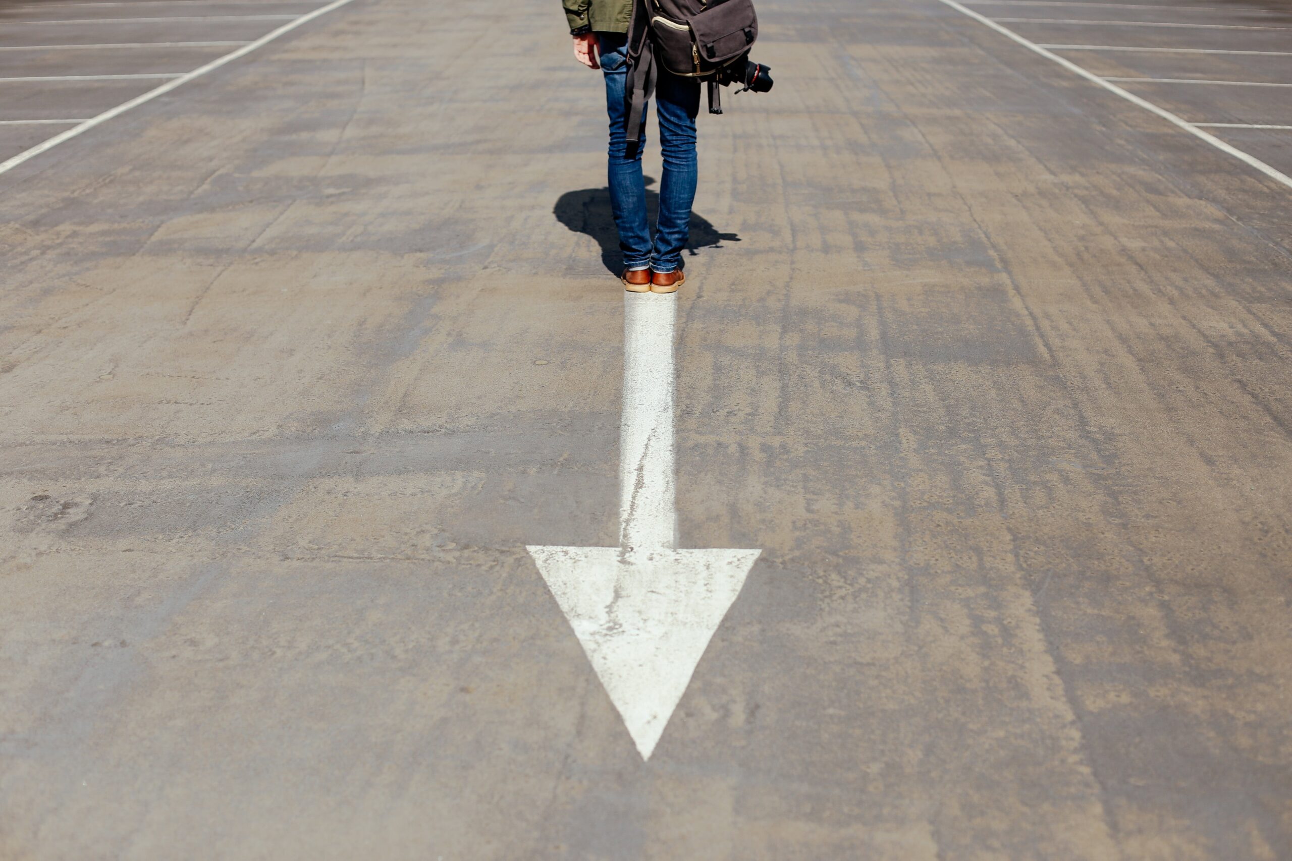 person walking on an arrow in the street autopilot patterns in midlife navigating uncertainty and change