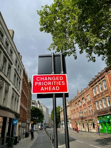 Changed priorities ahead sign in street life changes and unexpected events