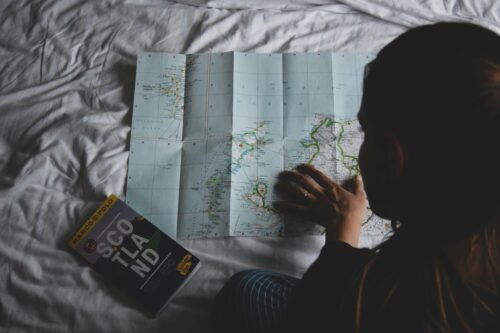 midlife expat woman looking at a map for next chapter of life