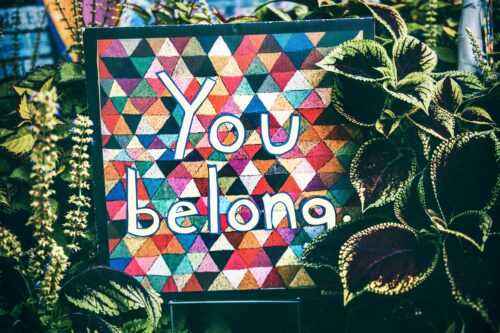 You belong written with colourful shapes midlife expat woman or mum coming home to self