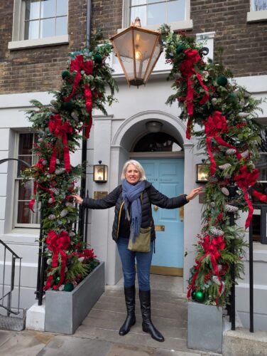 Emma Thorne Lees in London outside a Christmassy door the crossroads coach