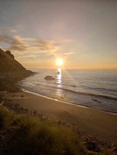 Carvajal beach and bay with sun in the distance, Fuengirola. Saltwater Sisters sea swim or dip