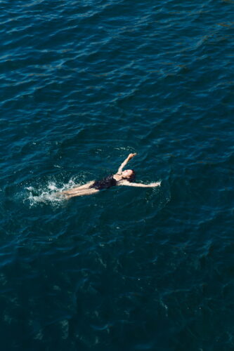 women laying in sea looking peaceful and relaxed and free sea or cold swimming benefits saltwater sisters